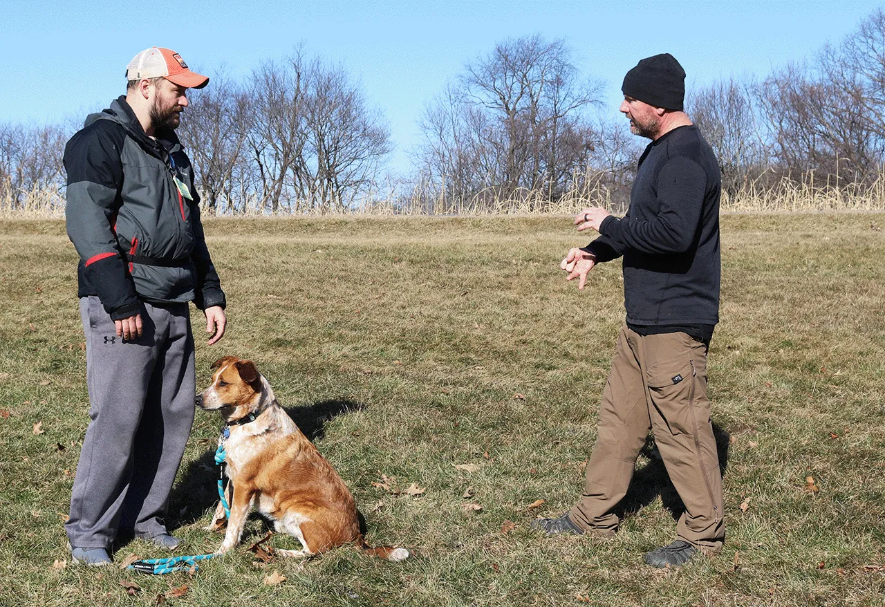 Brandon teaching a dog and dog owner how to work together.